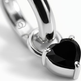 Rhodium-plated hoop with a heart-shaped black obsidian stone, close-up on white