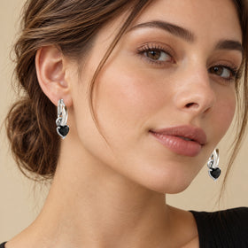 Model wearing the heart-shaped black obsidian hoop earring, face in three-quarter view
