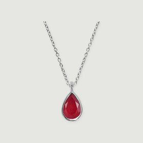A silver cable chain meets a polished bezel around a faceted pink teardrop stone on light gray.