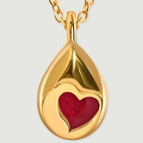 A close view of the yellow gold pendant back shows a heart-shaped opening over the pink stone.
