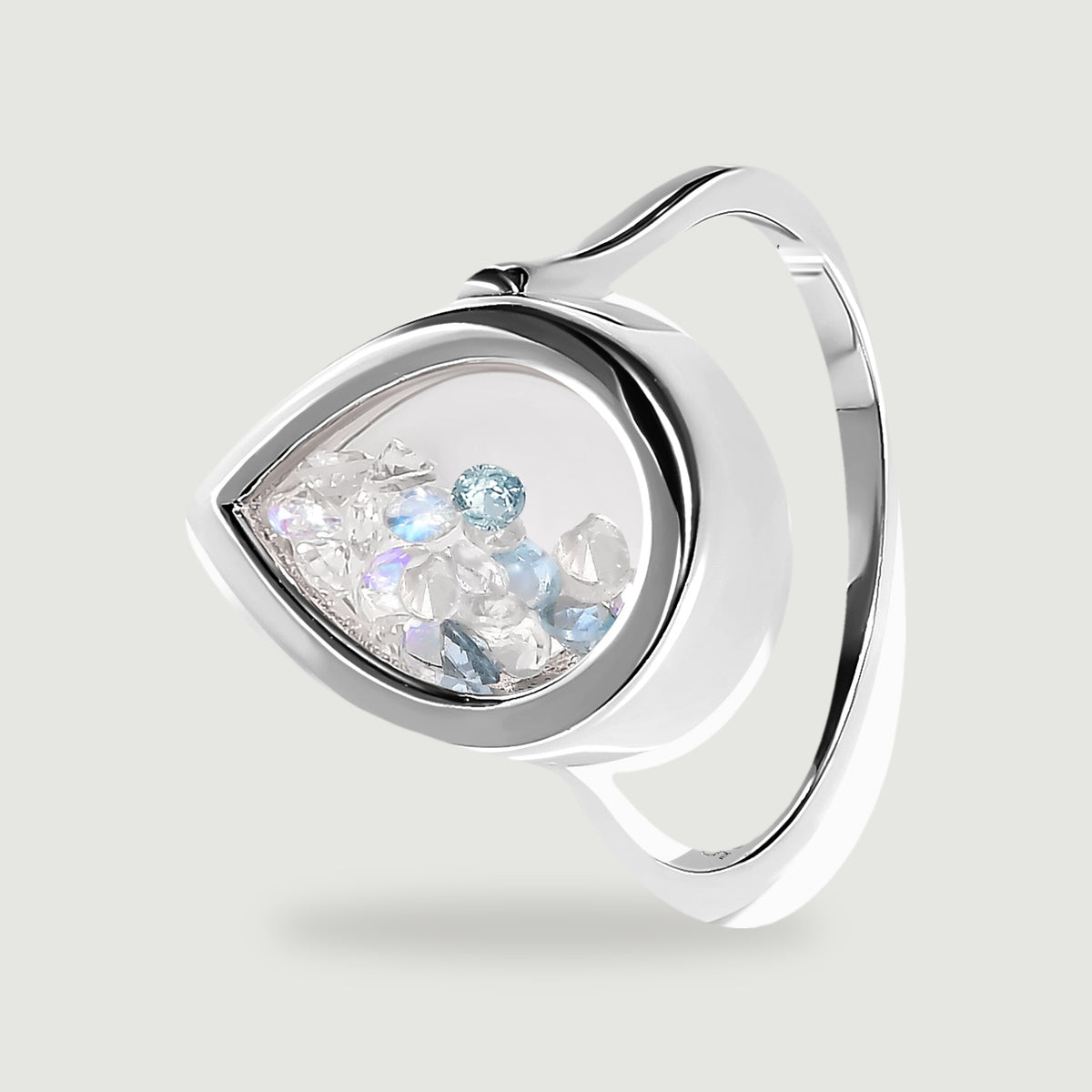 An angled silver ring reveals the depth of its glass-fronted setting and its curved band.