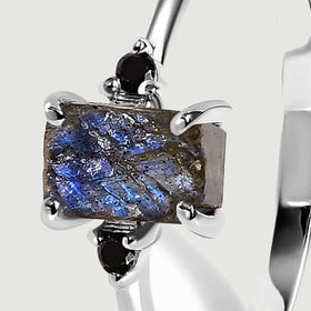 A side close-up of the sterling silver setting reveals the uneven depth of the labradorite and a black accent stone.