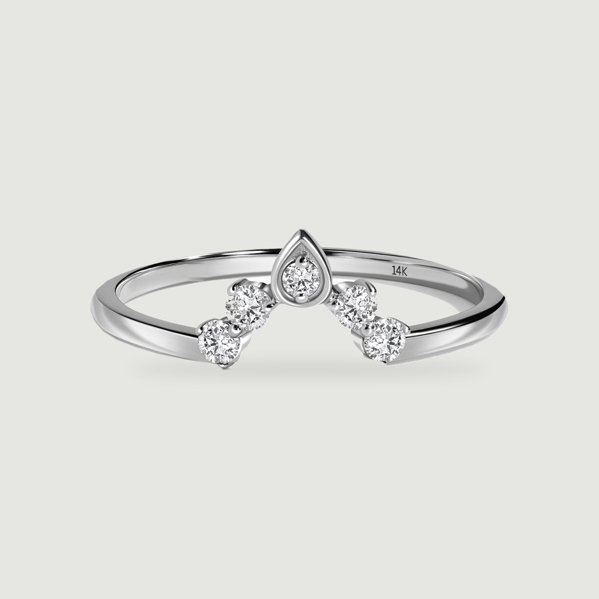 A white gold ring has four round diamonds arranged around a central pointed diamond setting.