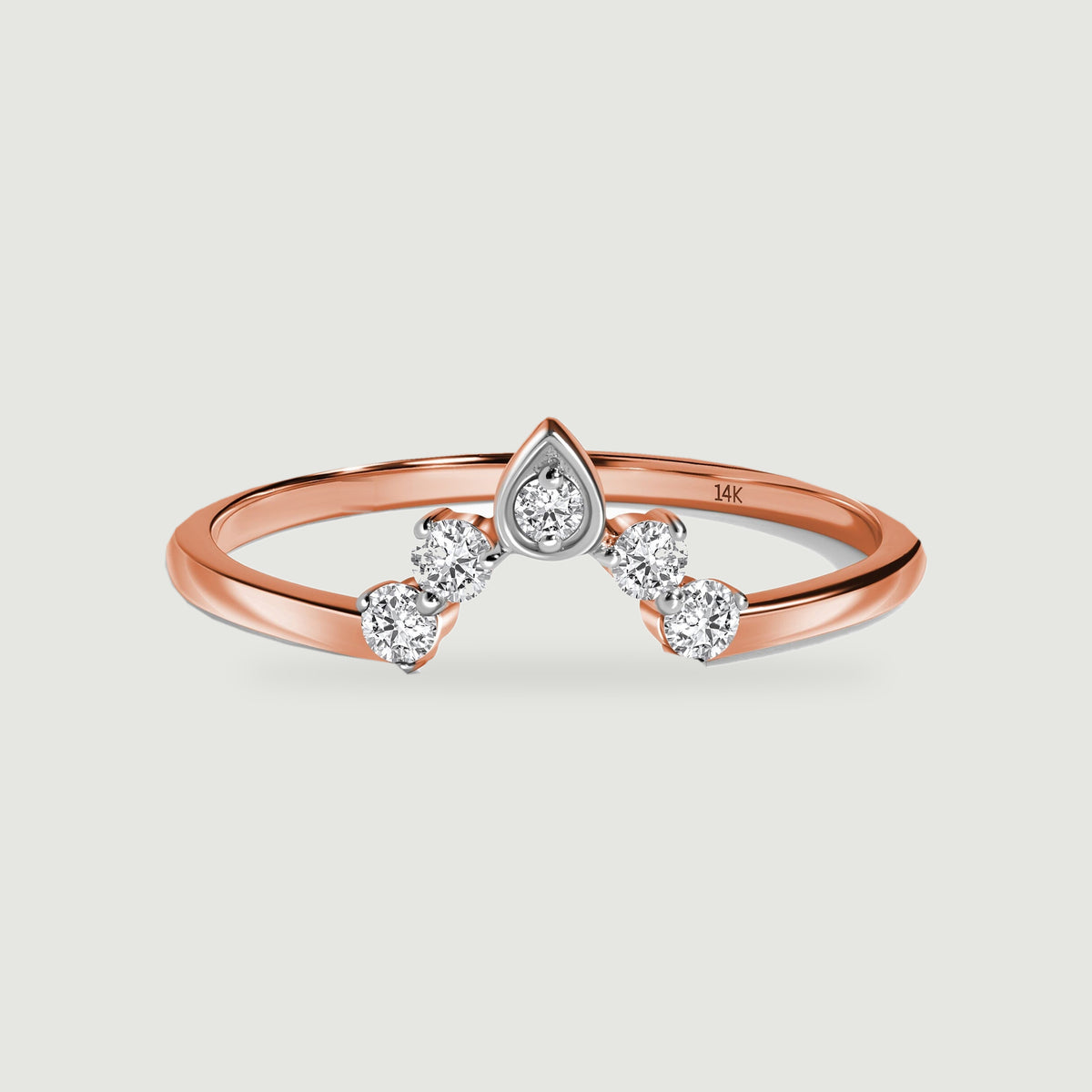 A rose gold band curves beneath five bright diamonds in a pointed crown arrangement.