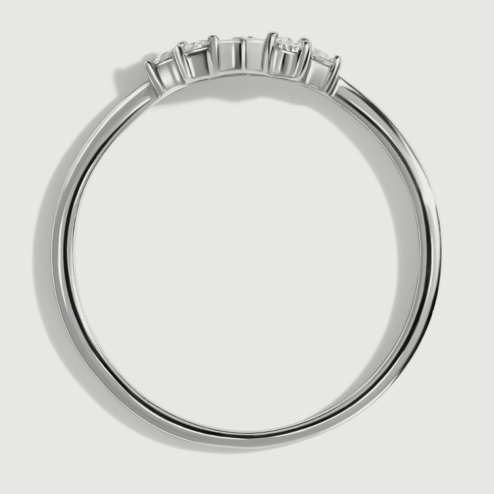 The white gold ring is shown from the side with raised settings above its slim circular band.