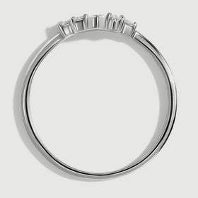 The white gold ring is shown from the side with raised settings above its slim circular band.