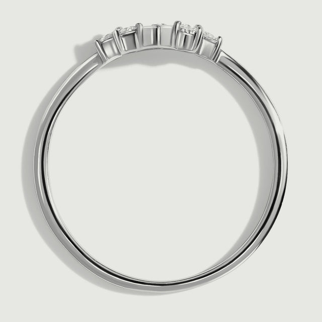 The white gold ring is shown from the side with raised settings above its slim circular band.