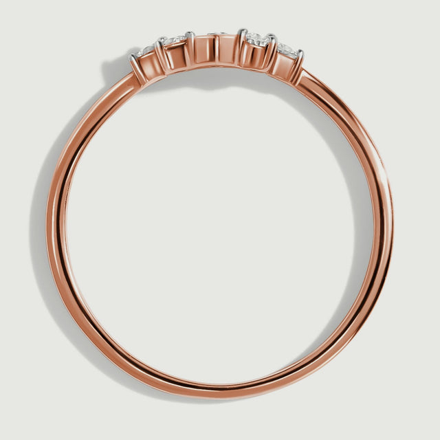 A side view of the rose gold ring shows the open band and the height of its diamond settings.