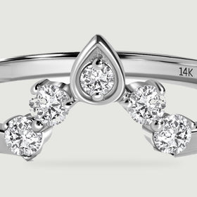 A close view shows the faceted round diamonds and pointed central setting of the white gold ring.