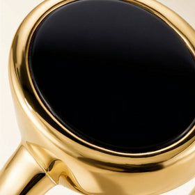 A close view shows the black onyx surface and rounded yellow gold vermeil bezel.