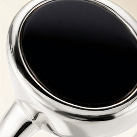 A magnified view reveals the dark oval stone and reflective sterling silver setting.