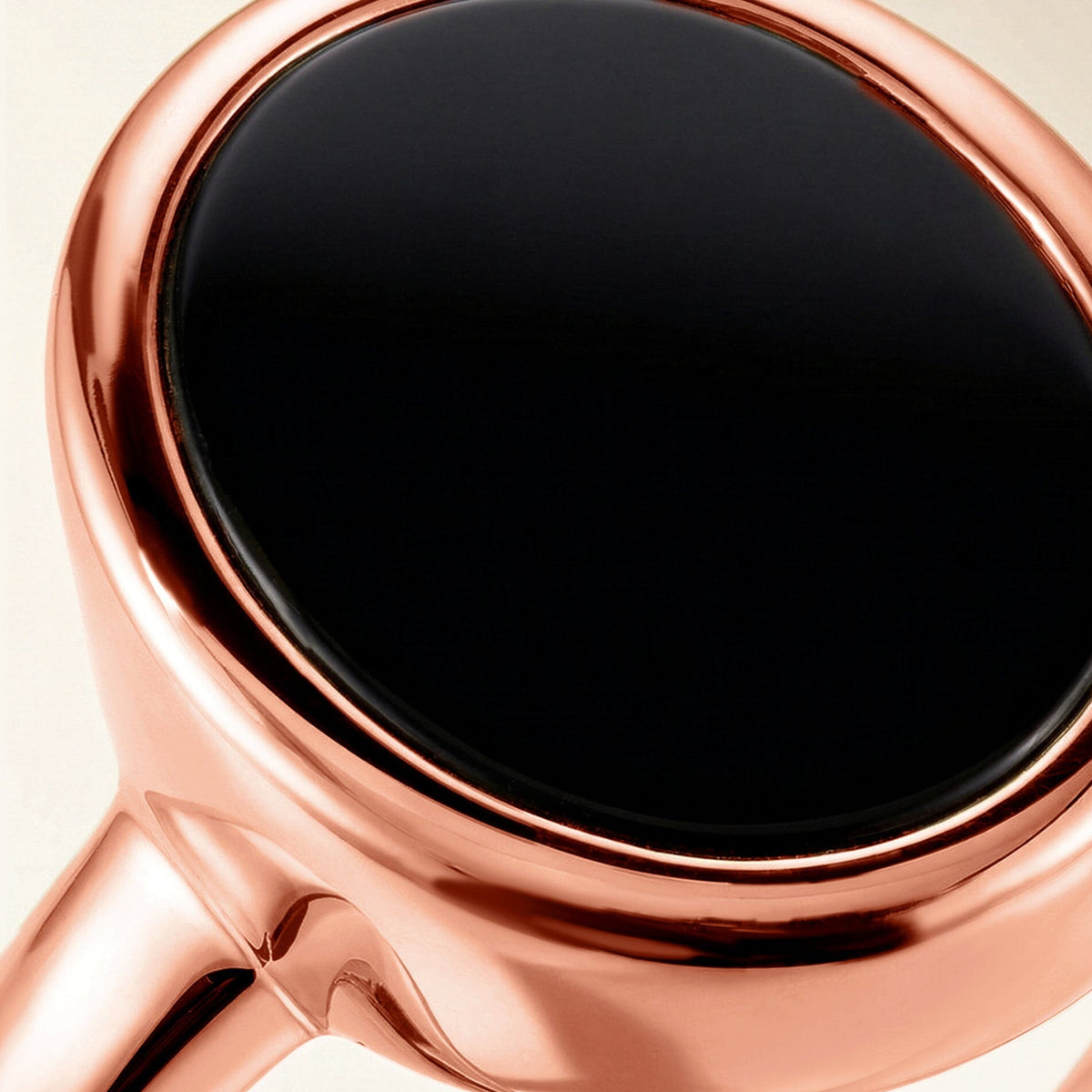 A detailed crop shows the glossy black onyx face inside its warm rose gold vermeil rim.