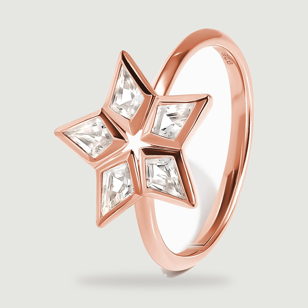 An angled rose gold ring reveals the raised stone settings and the curved band.