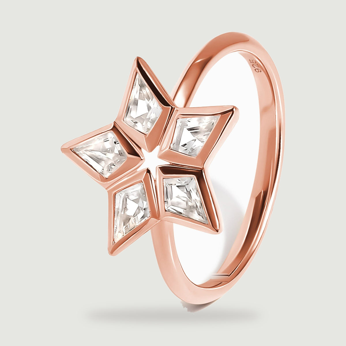 An angled rose gold ring reveals the raised stone settings and the curved band.