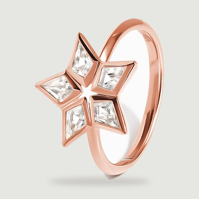 An angled rose gold ring reveals the raised stone settings and the curved band.