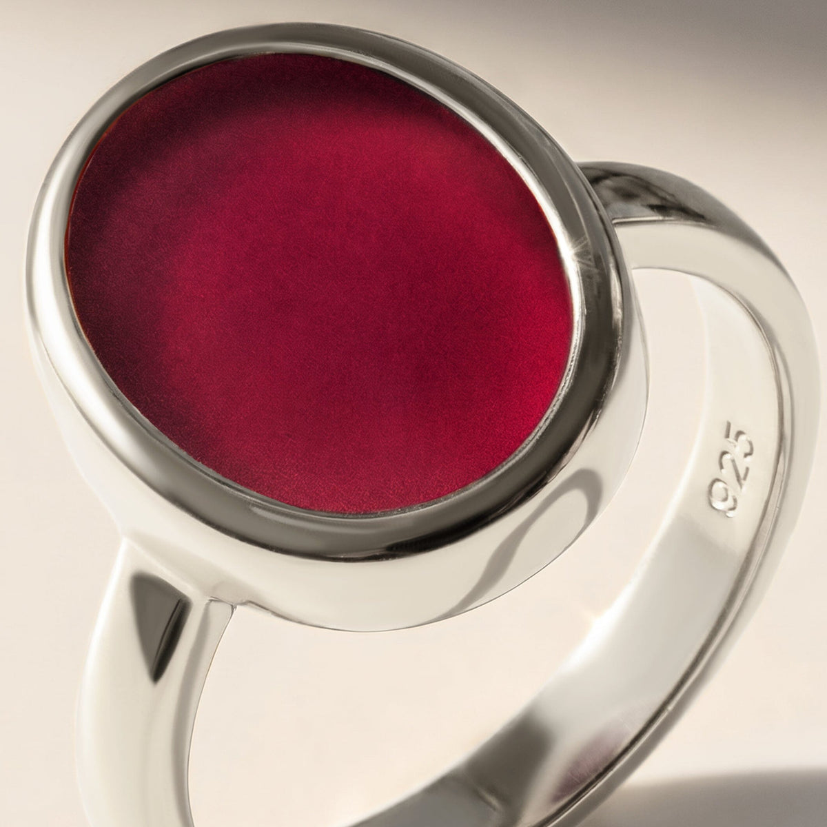 A close view of the pink stone and silver bezel shows the curved band and its 925 stamp.