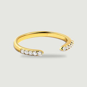 A yellow gold open ring displays clear round stones at both ends of its polished band.