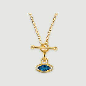 A yellow gold necklace with an oval blue gemstone, clear accent stones and a bar clasp is centered on a light gray background.