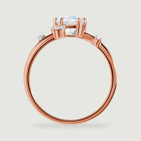 The rose gold ring is shown from the side with its open stone setting and slender circular band.