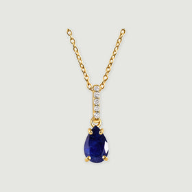 A yellow gold necklace has a pear-shaped blue sapphire below a vertical row of five clear stones.