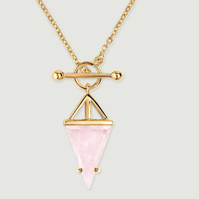 The yellow gold setting surrounds a pale pink faceted stone beneath a polished crossbar and round loop.