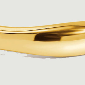 The yellow gold band fills the frame with a close view of its softly sculpted rim.