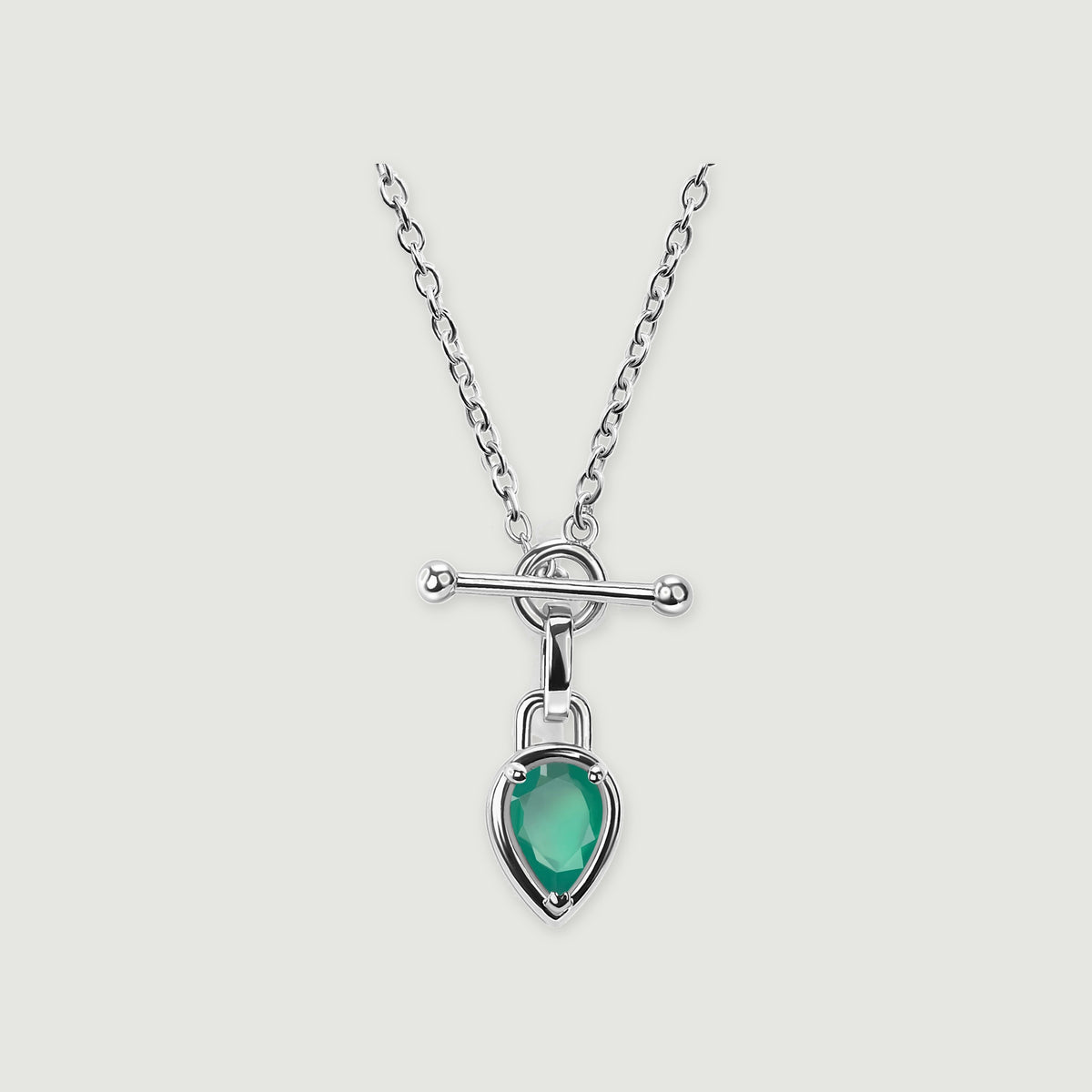 A white rhodium plated chain frames a green pear-shaped pendant beneath a silver-toned bar clasp.