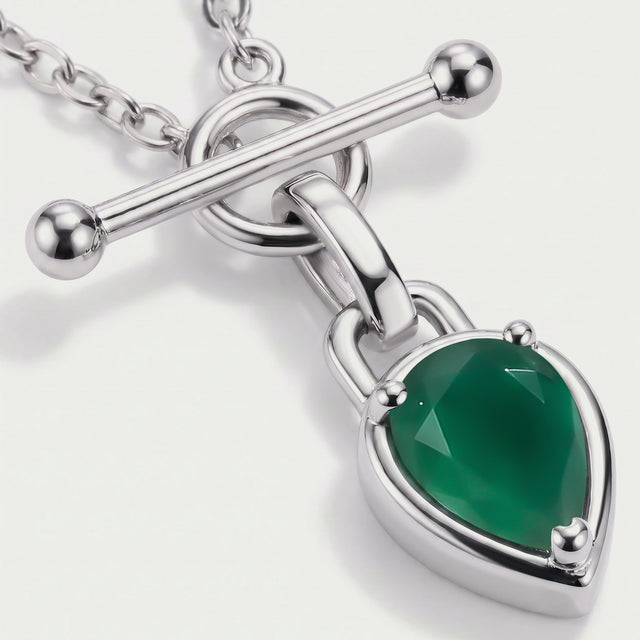 The green gemstone sits in a polished silver-toned setting with three rounded prongs and a connecting loop.