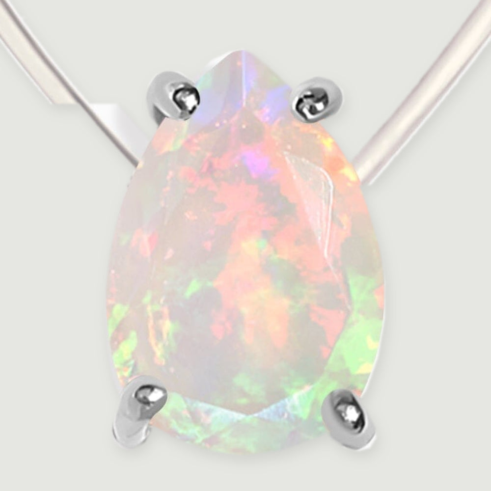 A close view shows the full pear-shaped opal and its four silver prongs against a light gray surface.