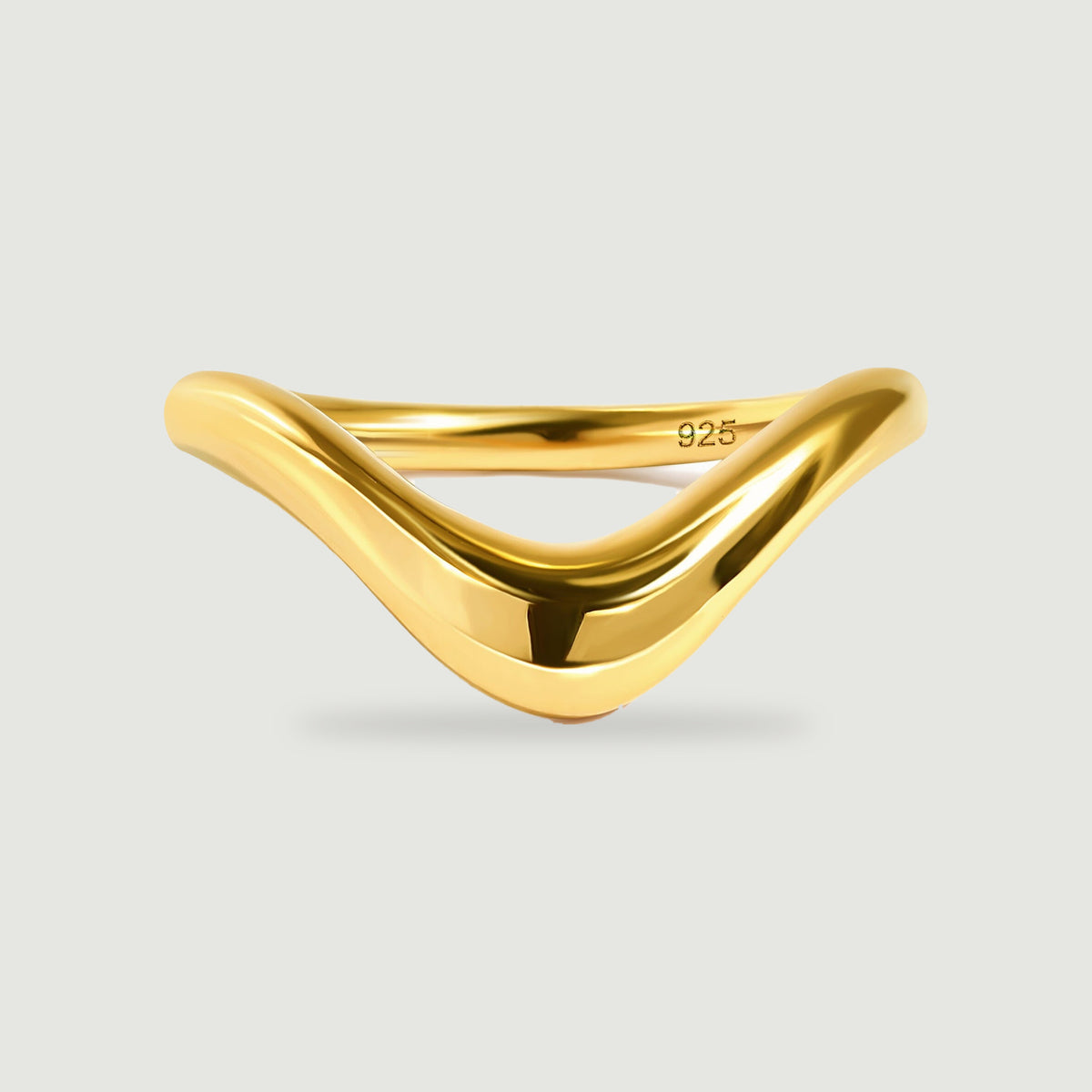 A polished yellow gold V-shaped band is centered on a light gray background.