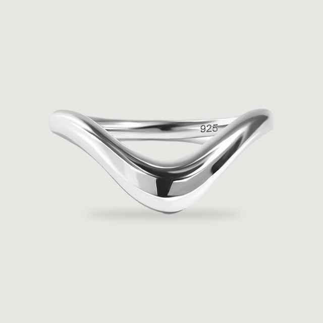 A smooth silver V-shaped ring is shown from the front with a soft contact shadow.