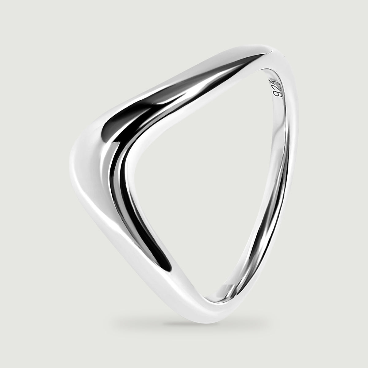 The silver band is tilted to show its curved profile and inner opening.