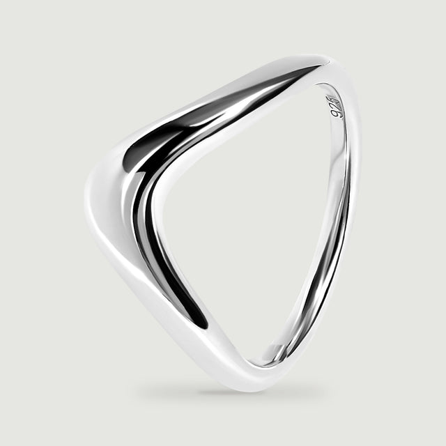 The silver band is tilted to show its curved profile and inner opening.