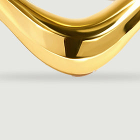 A close view shows the broad yellow gold curve and its reflective rounded surface.