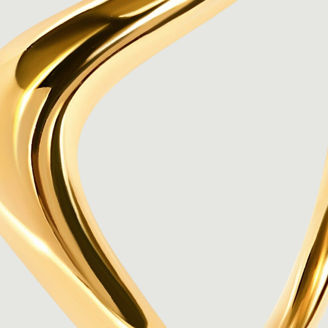 A close-up of the yellow gold shoulder shows the band tapering toward the back.