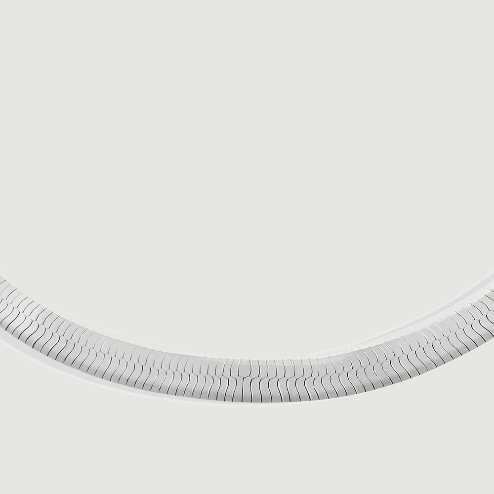 A close view shows the interlocking silver links along the curved lower section of the bracelet.