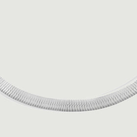 A close view shows the interlocking silver links along the curved lower section of the bracelet.