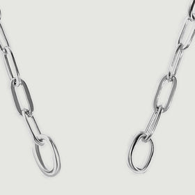 Two circular silver end rings connect to elongated chain links in this close view.