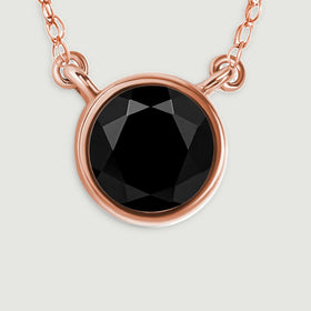 The black onyx facets and warm rose gold rim are visible beside the small connecting links.