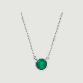 A green onyx stone in a polished white gold setting is attached to a delicate chain on soft gray.