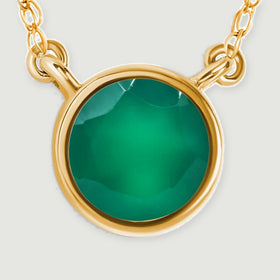 A close view shows the green onyx facets, smooth yellow gold bezel, and two chain attachment loops.