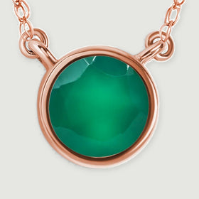 The circular green gemstone and curved rose gold rim fill a close-up with short chain sections above.