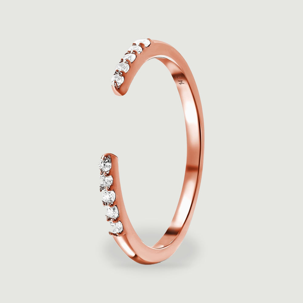 An upright side view shows the curved rose gold band, raised diamond settings and 14K stamp.