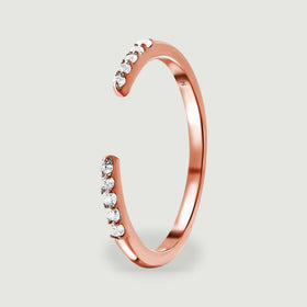 An upright side view shows the curved rose gold band, raised diamond settings and 14K stamp.