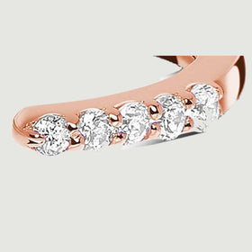 The right diamond row ends at a rounded rose gold tip beside the central opening.