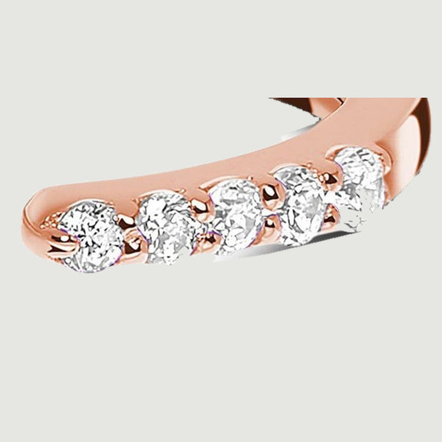 The right diamond row ends at a rounded rose gold tip beside the central opening.