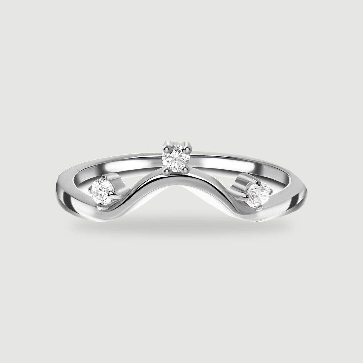 A polished silver wave band holds three round clear stones against a light grey background.