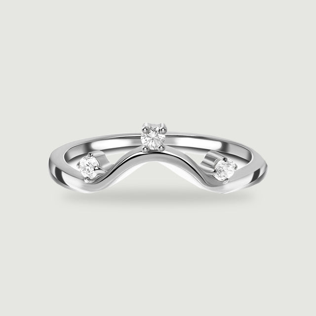 A polished silver wave band holds three round clear stones against a light grey background.
