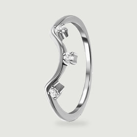 An angled silver ring shows its curved band and the raised prongs around three clear stones.