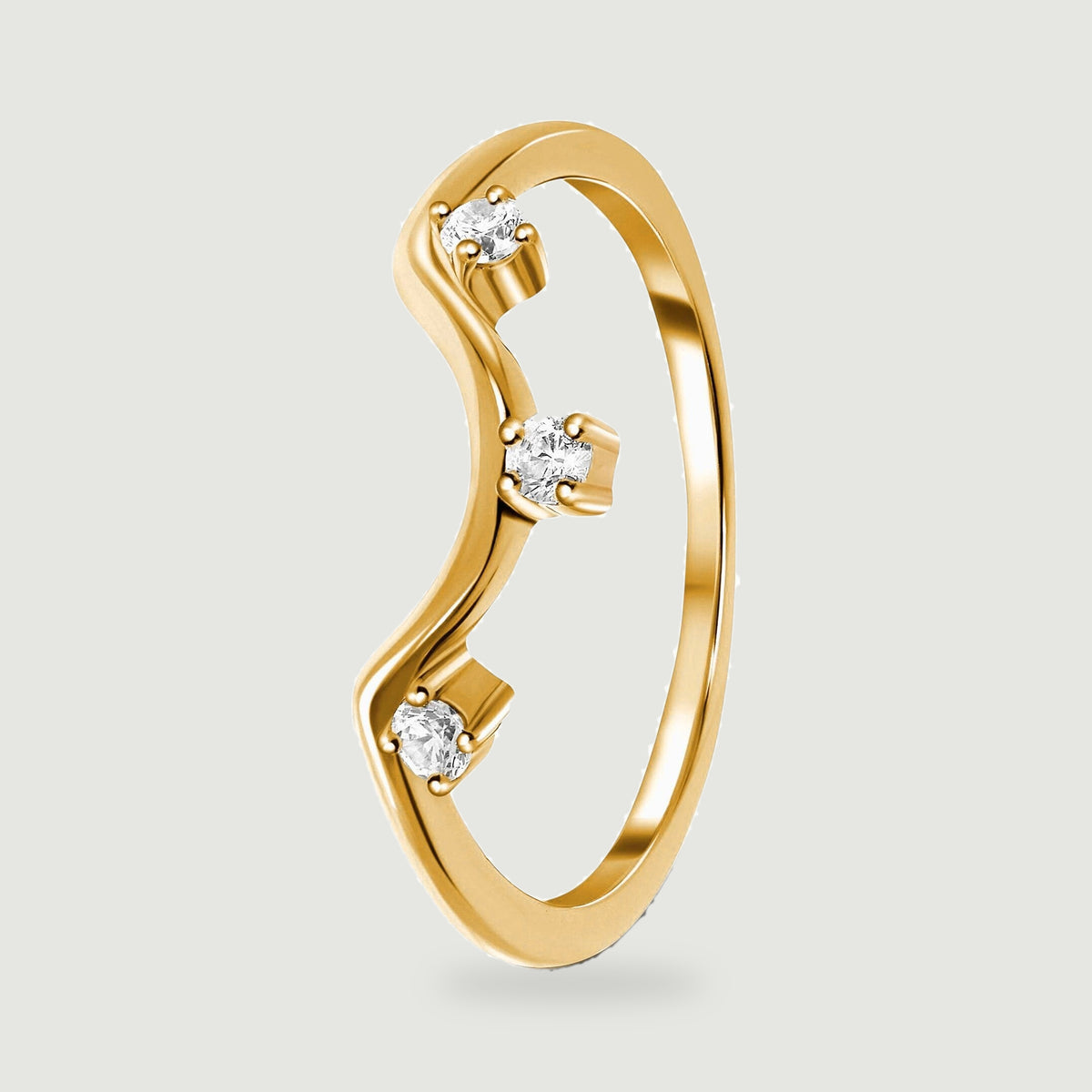 The side view of a yellow gold ring reveals an open circular band and three elevated stone settings.
